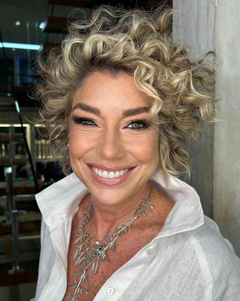  2.Textured Crop with Side Sweep Elegant Short Curly Hairstyle for Women Over 50